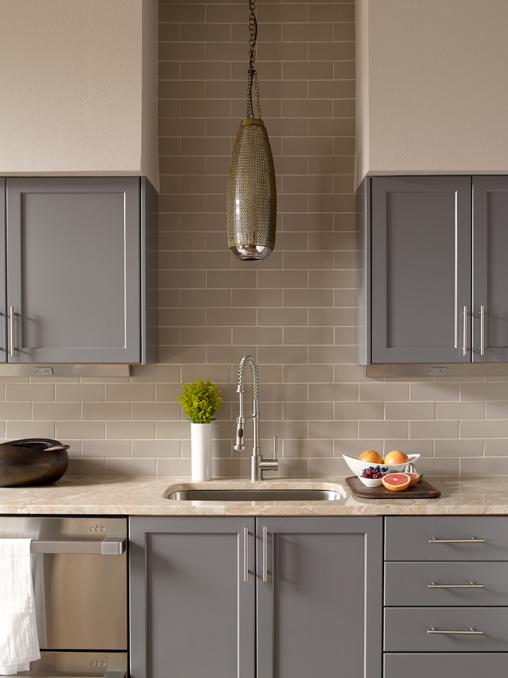 Example of a transitional kitchen design in Seattle with an undermount sink, shaker cabinets, gray cabinets, gray backsplash, subway tile backsplash and stainless steel appliances