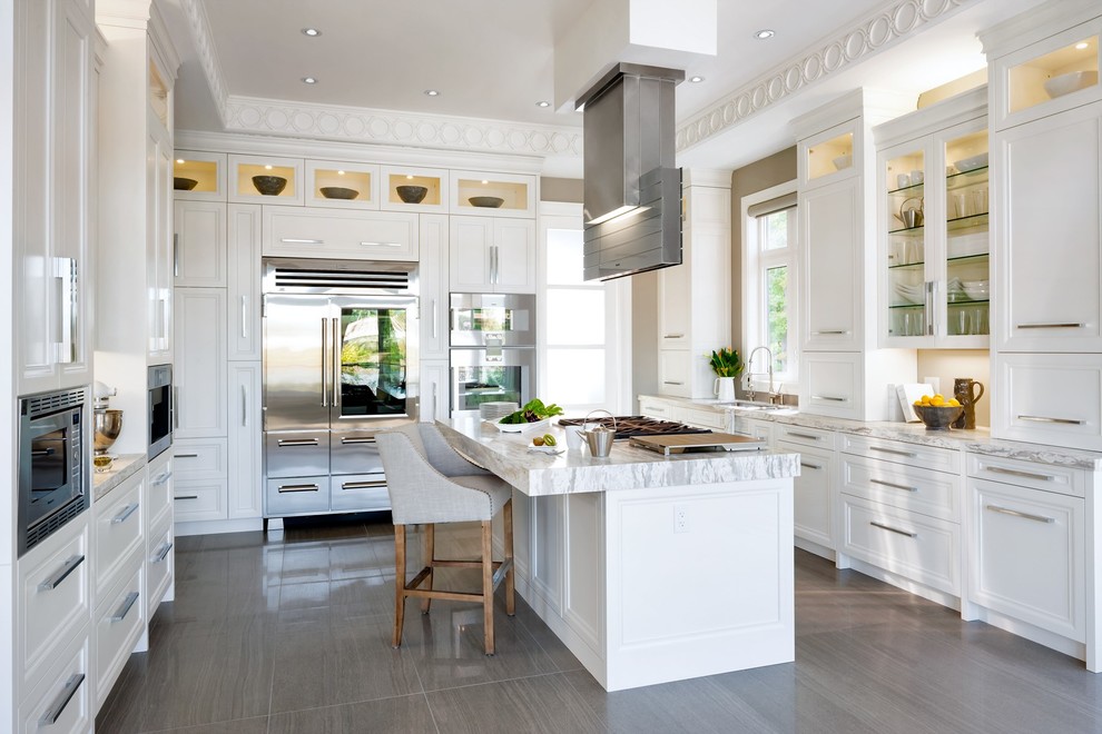 Design ideas for a large classic u-shaped kitchen in Toronto with a submerged sink, recessed-panel cabinets, white cabinets, beige splashback, stainless steel appliances and an island.