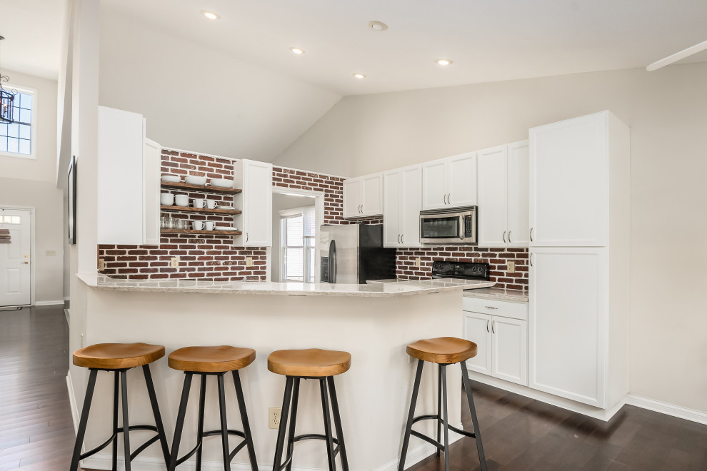 Inspiration for a medium sized traditional u-shaped kitchen/diner in Columbus with shaker cabinets, white cabinets, engineered stone countertops and brick splashback.