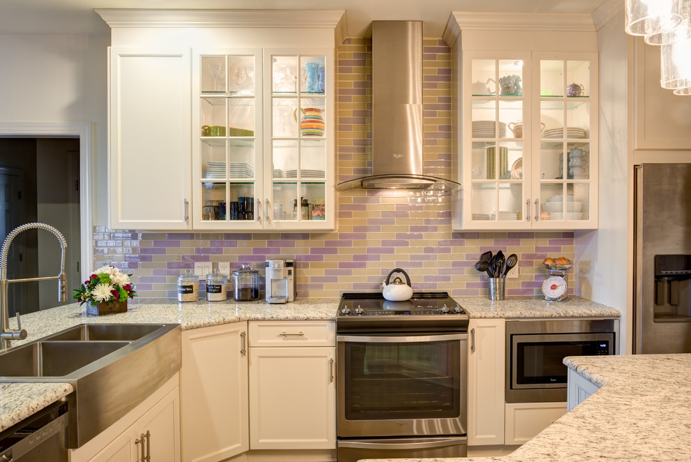Small transitional l-shaped dark wood floor enclosed kitchen photo in Raleigh with a double-bowl sink, granite countertops, multicolored backsplash, glass tile backsplash, stainless steel appliances and an island
