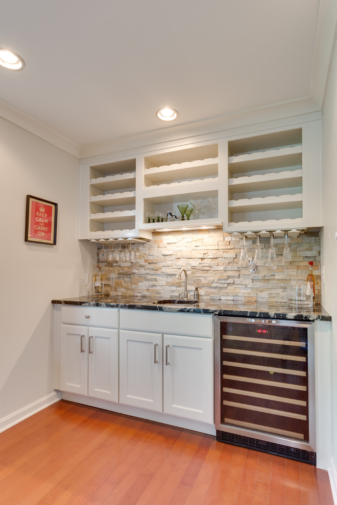 Example of a large transitional home bar design in DC Metro with flat-panel cabinets, white cabinets and granite countertops