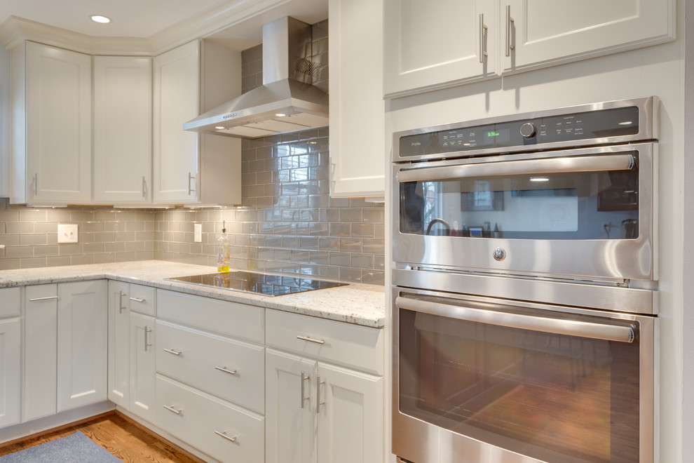 Kitchen - large transitional u-shaped kitchen idea in DC Metro with an undermount sink, recessed-panel cabinets, stainless steel appliances and an island