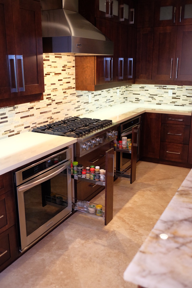 Medium sized traditional l-shaped open plan kitchen in Miami with a submerged sink, shaker cabinets, dark wood cabinets, marble worktops, multi-coloured splashback, matchstick tiled splashback, stainless steel appliances, travertine flooring and an island.