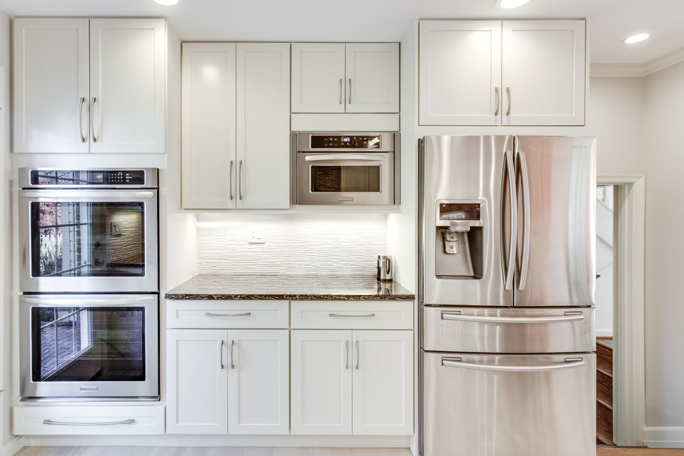 Inspiration for a large transitional u-shaped kitchen remodel in DC Metro with an undermount sink, shaker cabinets, white cabinets, quartz countertops, stainless steel appliances and a peninsula