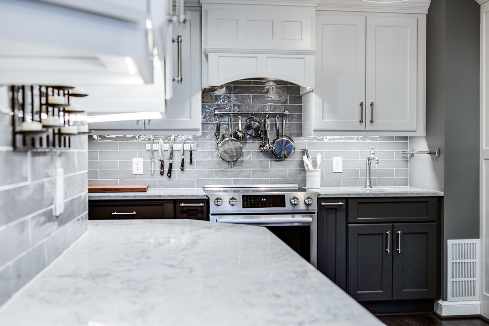 Design ideas for a large traditional kitchen in Baltimore with a belfast sink, recessed-panel cabinets, engineered stone countertops, grey splashback, stainless steel appliances, medium hardwood flooring and no island.