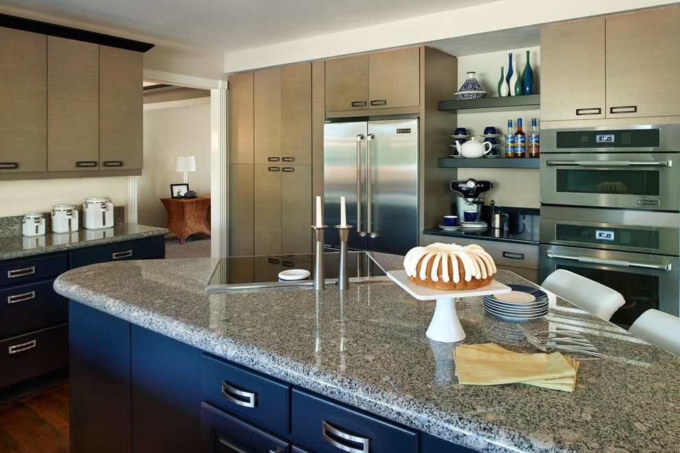 This is an example of a large classic u-shaped kitchen/diner in Denver with a submerged sink, flat-panel cabinets, black cabinets, granite worktops, stainless steel appliances, dark hardwood flooring and an island.