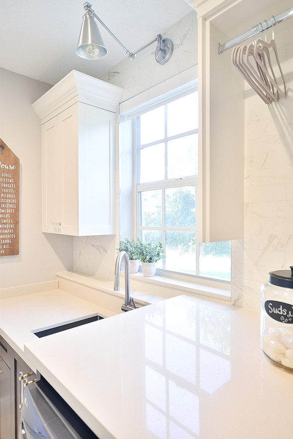 This is an example of a large classic u-shaped kitchen/diner in Other with a belfast sink, flat-panel cabinets, white cabinets, marble worktops, multi-coloured splashback, ceramic splashback, stainless steel appliances, porcelain flooring, an island, white floors and white worktops.
