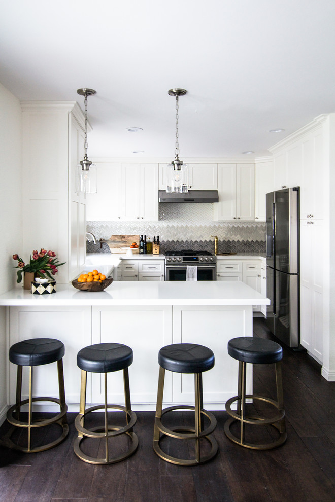 Example of a small transitional u-shaped dark wood floor open concept kitchen design in Los Angeles with a farmhouse sink, shaker cabinets, white cabinets, quartz countertops, multicolored backsplash, mosaic tile backsplash, stainless steel appliances and a peninsula
