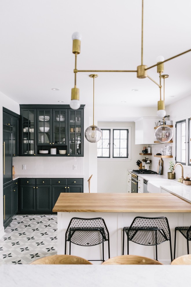 Kitchen - transitional u-shaped kitchen idea in DC Metro with a farmhouse sink, shaker cabinets, paneled appliances and a peninsula