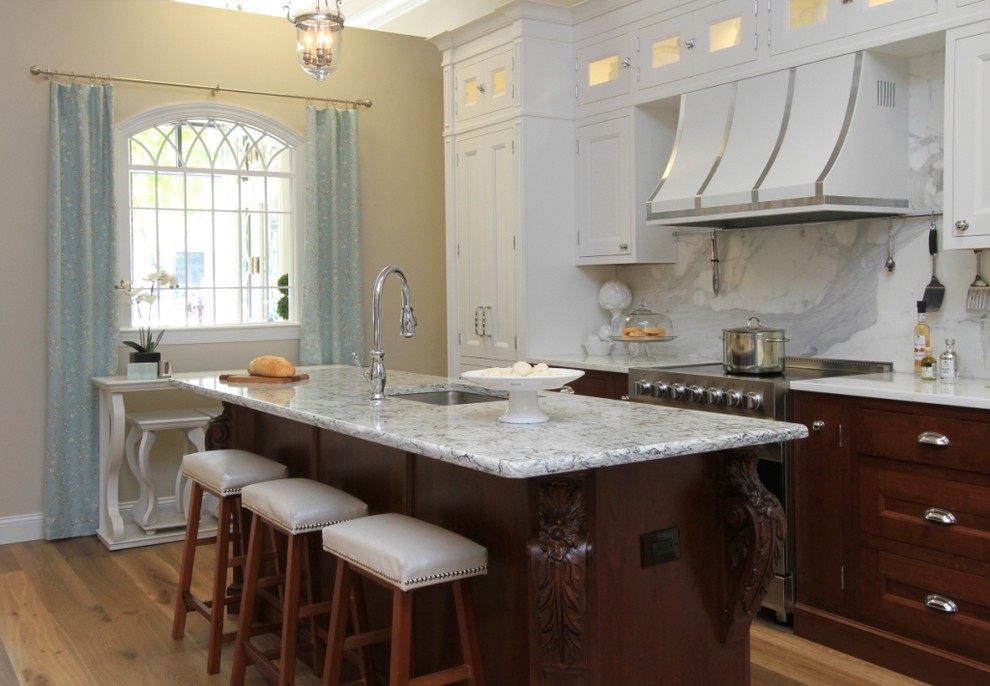 Inspiration for a mid-sized transitional single-wall medium tone wood floor and brown floor eat-in kitchen remodel in Jacksonville with an undermount sink, flat-panel cabinets, dark wood cabinets, quartz countertops, white backsplash, stone slab backsplash, stainless steel appliances, an island and white countertops