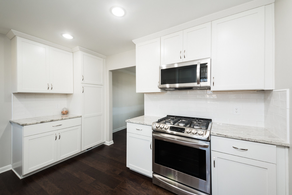 Eat-in kitchen - mid-sized transitional u-shaped eat-in kitchen idea in Columbus with an undermount sink, shaker cabinets, white cabinets, granite countertops, white backsplash, subway tile backsplash and stainless steel appliances