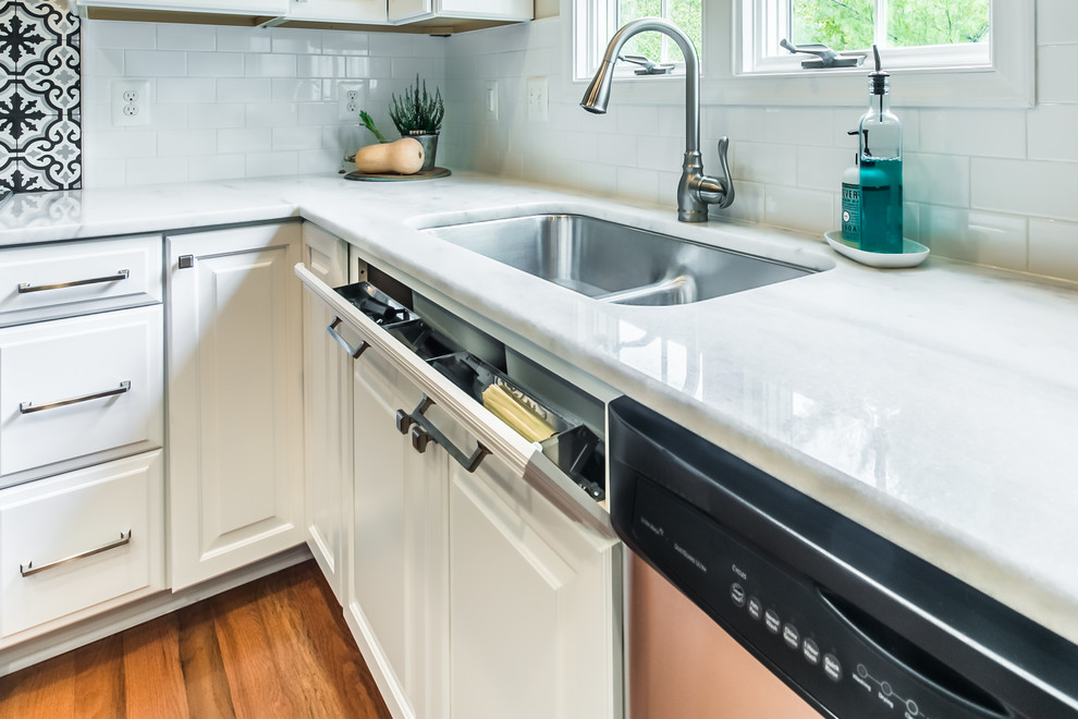 Inspiration for a large transitional l-shaped medium tone wood floor and brown floor eat-in kitchen remodel in DC Metro with an undermount sink, raised-panel cabinets, white cabinets, quartz countertops, white backsplash, cement tile backsplash, stainless steel appliances and an island