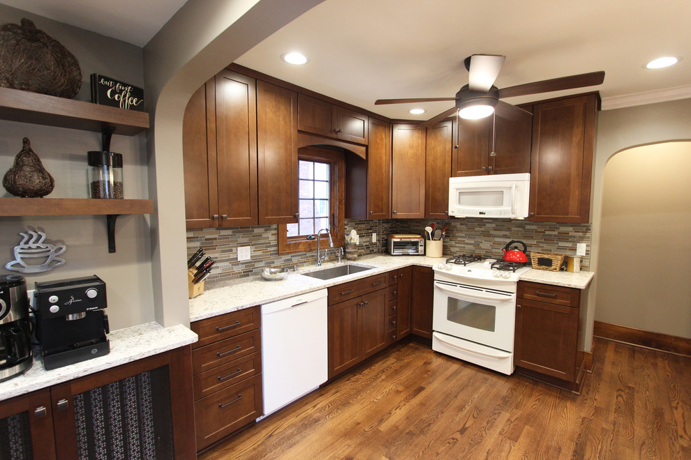 Mid-sized transitional l-shaped medium tone wood floor and brown floor kitchen pantry photo in Cleveland with an undermount sink, shaker cabinets, medium tone wood cabinets, quartz countertops, brown backsplash, glass tile backsplash, white appliances and an island