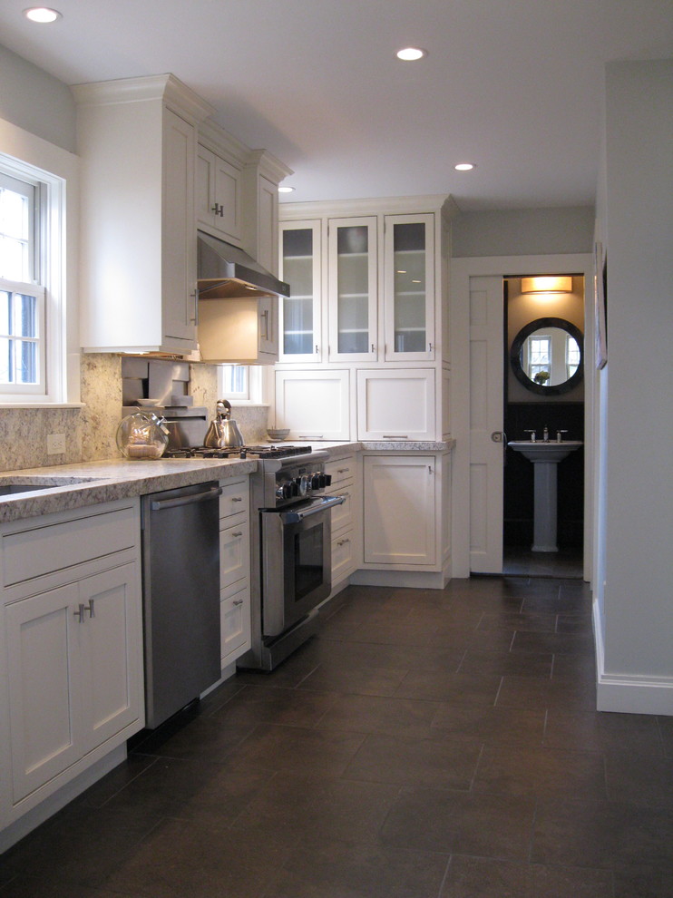 Example of a mid-sized classic galley porcelain tile and brown floor enclosed kitchen design in Boston with an undermount sink, beaded inset cabinets, beige cabinets, granite countertops, multicolored backsplash, granite backsplash, stainless steel appliances, no island and multicolored countertops