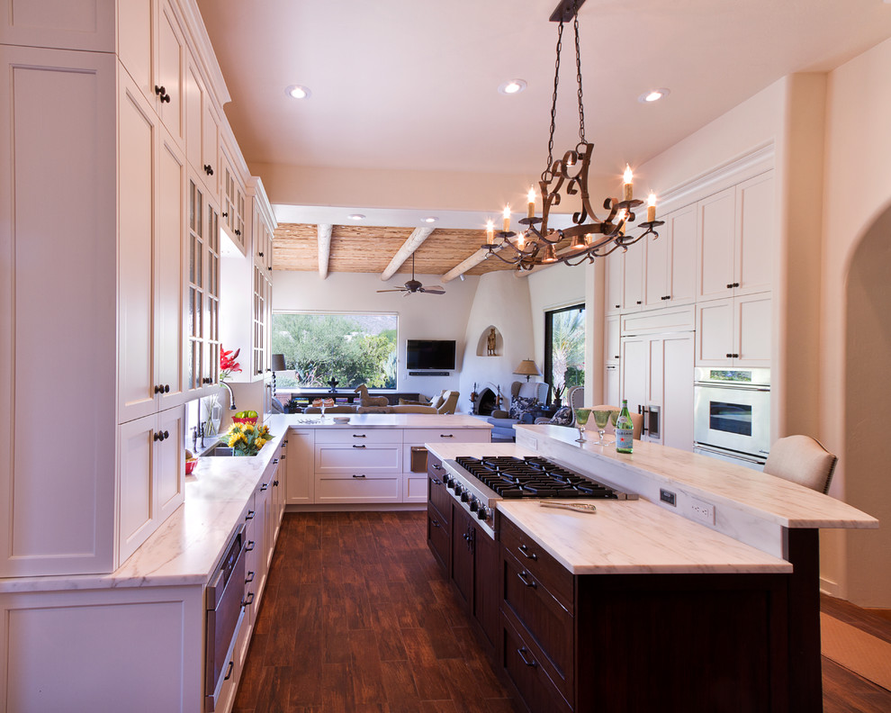 Inspiration for a large traditional kitchen in Phoenix with shaker cabinets, stainless steel appliances and an island.