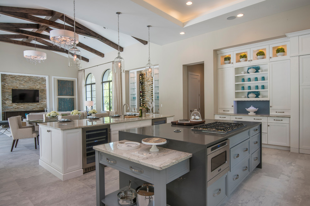 Transitional porcelain tile and gray floor eat-in kitchen photo in Orlando with a drop-in sink, flat-panel cabinets, white cabinets, marble countertops, blue backsplash, glass sheet backsplash, stainless steel appliances, two islands and beige countertops