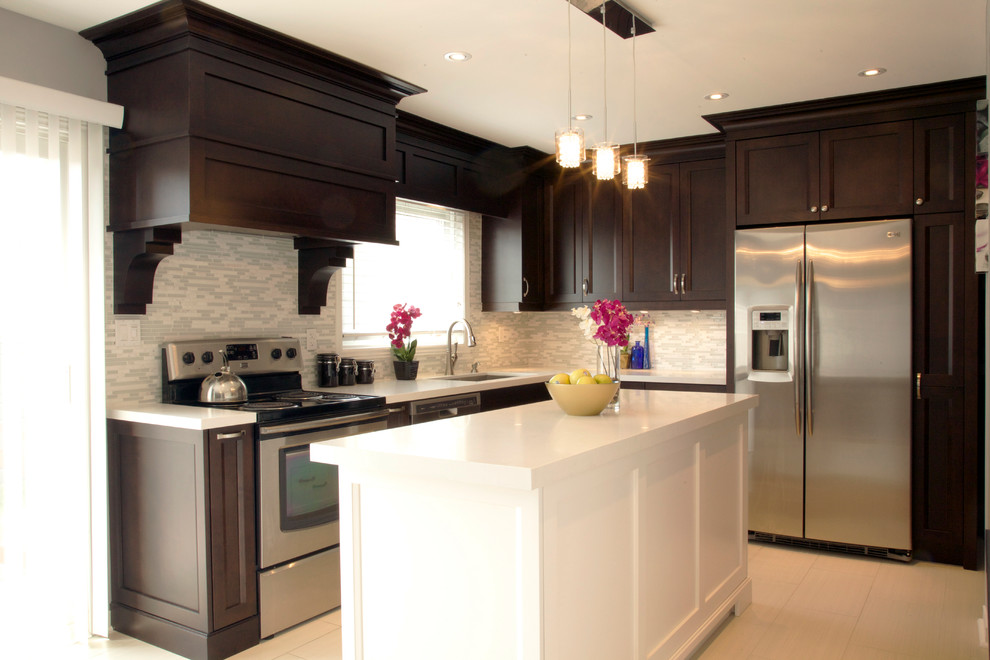 This is an example of a medium sized traditional l-shaped kitchen/diner in Toronto with a built-in sink, shaker cabinets, engineered stone countertops, glass tiled splashback, stainless steel appliances, porcelain flooring and an island.