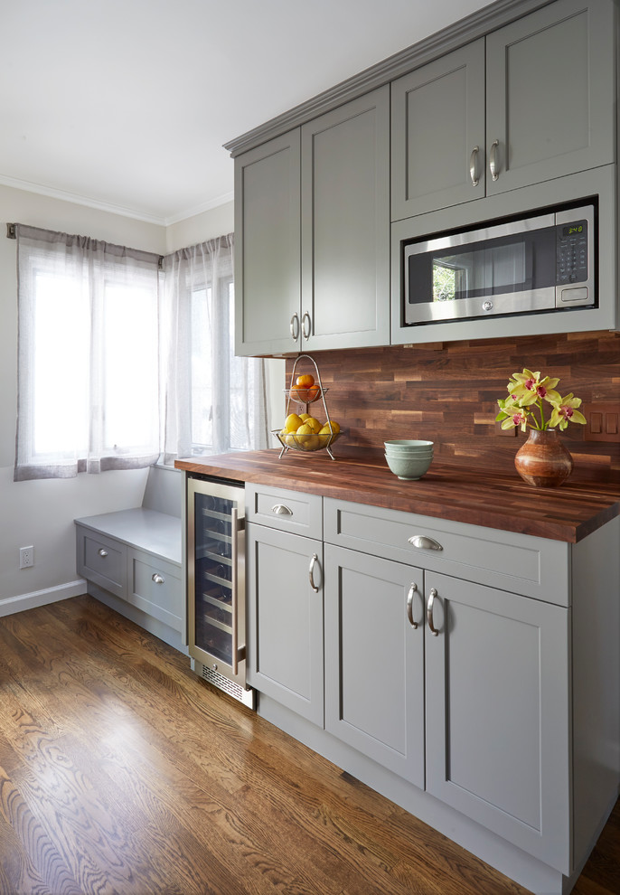 Example of a mid-sized transitional brown floor and dark wood floor kitchen design in San Francisco with shaker cabinets, gray cabinets, wood countertops, brown backsplash, stainless steel appliances, brown countertops and wood backsplash
