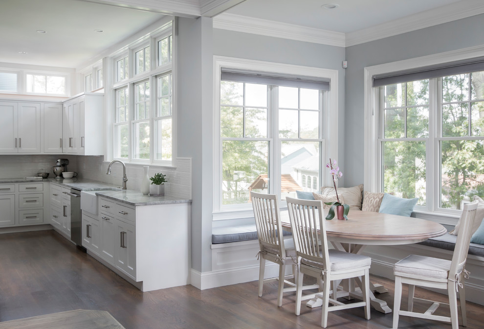 Transitional open concept kitchen photo in Boston with a farmhouse sink, beaded inset cabinets, white cabinets, marble countertops, white backsplash, ceramic backsplash, stainless steel appliances and an island