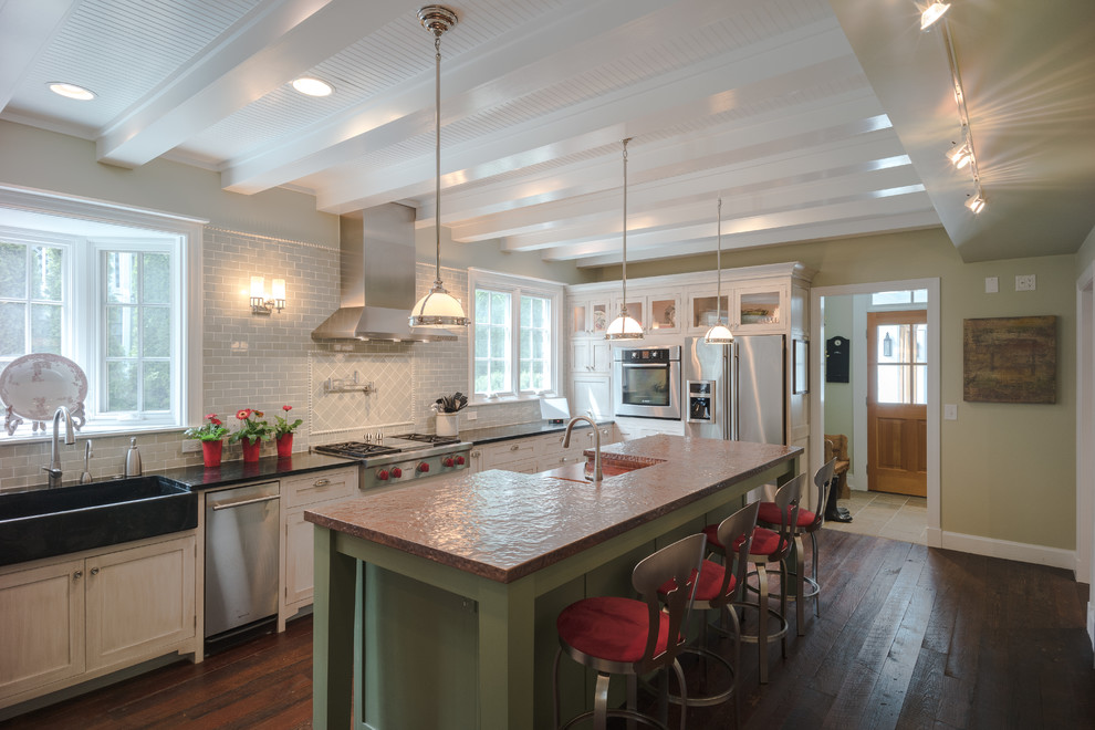 Inspiration for a mid-sized transitional u-shaped dark wood floor enclosed kitchen remodel in Atlanta with a farmhouse sink, recessed-panel cabinets, white cabinets, copper countertops, green backsplash, ceramic backsplash, stainless steel appliances and an island