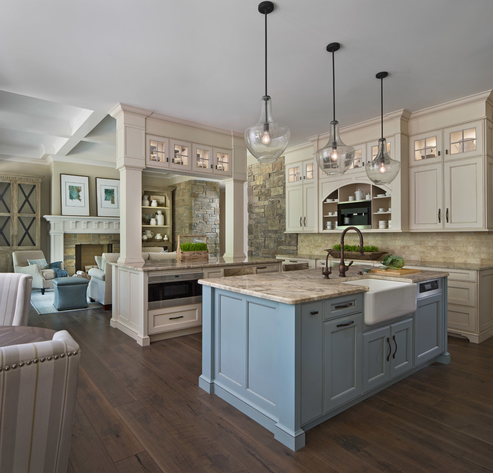 This is an example of a traditional open plan kitchen in Detroit with a belfast sink, recessed-panel cabinets, blue cabinets, beige splashback, dark hardwood flooring, brown floors, beige worktops and an island.