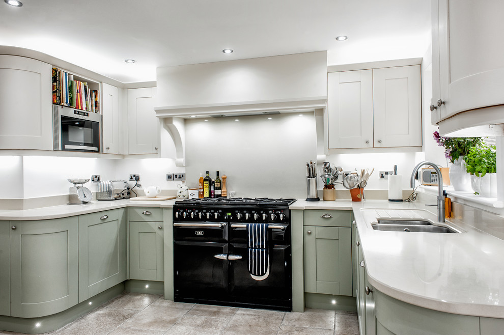 Inspiration for a classic u-shaped kitchen in Other with a double-bowl sink, shaker cabinets, grey cabinets, white splashback, black appliances, no island, beige floors and white worktops.