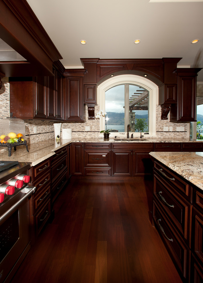 Huge mountain style u-shaped porcelain tile and beige floor open concept kitchen photo in Other with an undermount sink, raised-panel cabinets, dark wood cabinets, granite countertops, red backsplash, porcelain backsplash, stainless steel appliances and a peninsula