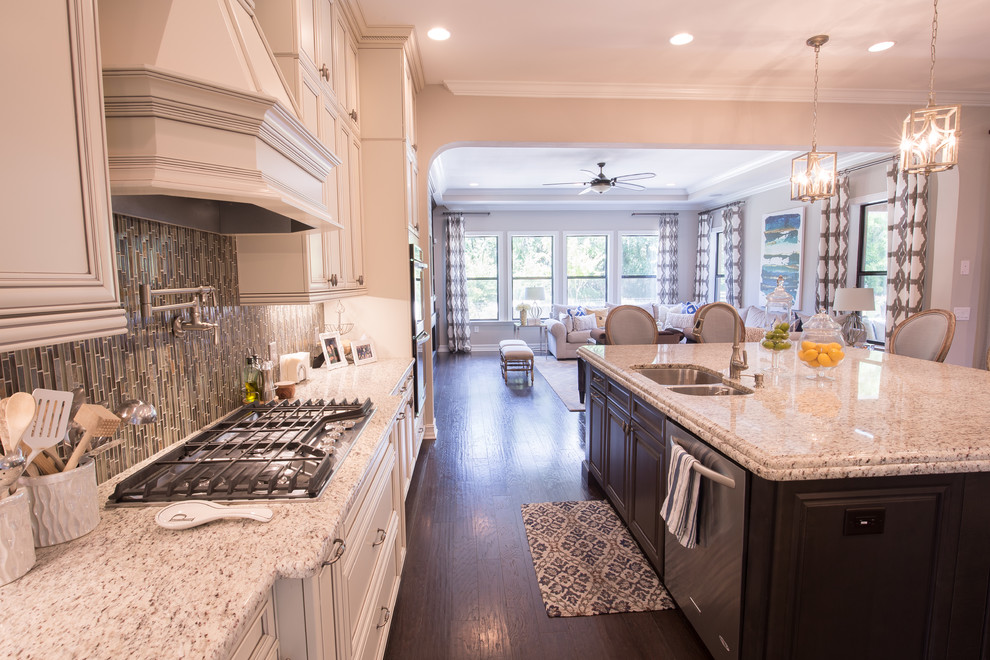 Inspiration for a large transitional dark wood floor eat-in kitchen remodel in Orange County with a double-bowl sink, recessed-panel cabinets, white cabinets, granite countertops, multicolored backsplash, matchstick tile backsplash, stainless steel appliances and an island