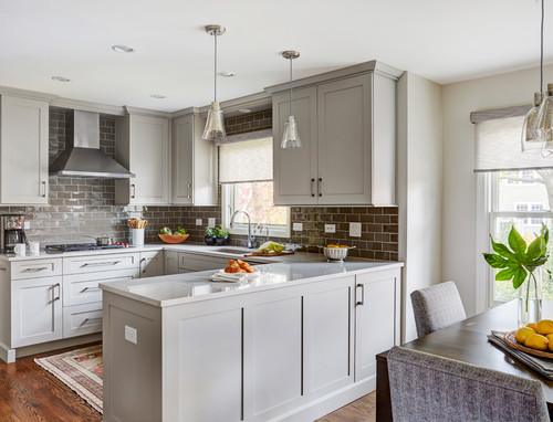 Kitchens and Bathrooms: light-gray shaker kitchen with quartz peninsula, taupe glossy subway backsplash, stainless hood, and glass pendants.
