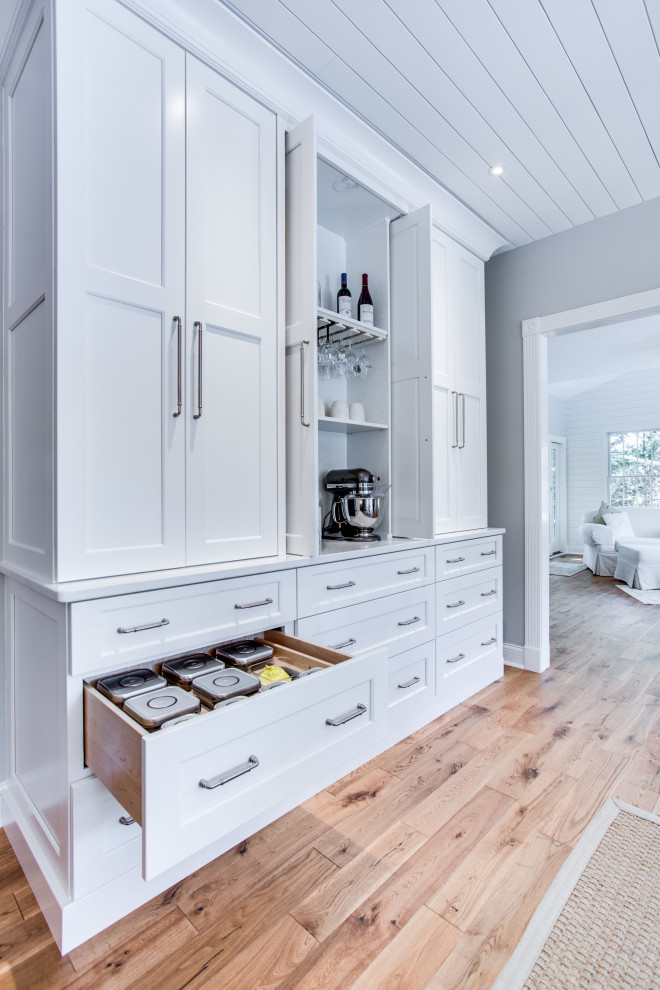 Diseño de cocina clásica renovada, grande, con fregadero bajoencimera, armarios con paneles empotrados, encimera de cuarzo compacto, salpicadero blanco, salpicadero de azulejos tipo metro, electrodomésticos de acero inoxidable y una isla