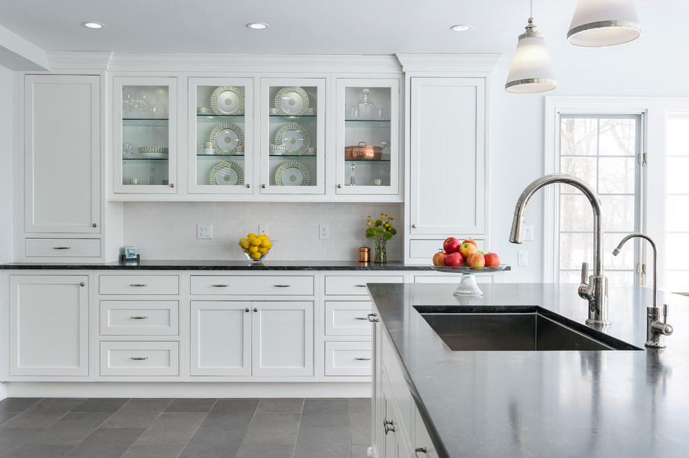 Eat-in kitchen - huge transitional u-shaped porcelain tile eat-in kitchen idea in New York with an undermount sink, beaded inset cabinets, white cabinets, granite countertops, white backsplash, subway tile backsplash, stainless steel appliances and an island