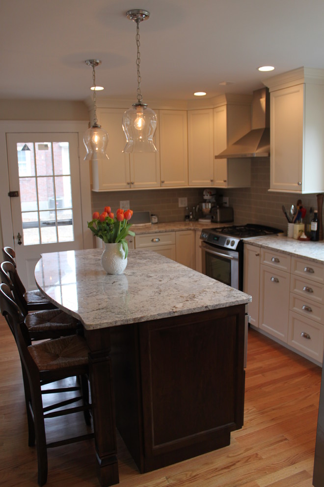 Eat-in kitchen - mid-sized transitional u-shaped light wood floor eat-in kitchen idea in Boston with an undermount sink, recessed-panel cabinets, white cabinets, granite countertops, beige backsplash, glass tile backsplash, stainless steel appliances and an island