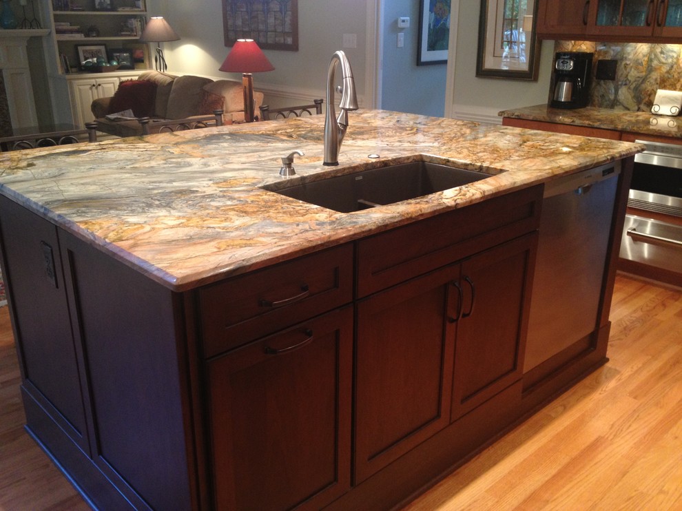 Transitional light wood floor eat-in kitchen photo in Raleigh with shaker cabinets, medium tone wood cabinets, granite countertops and an island