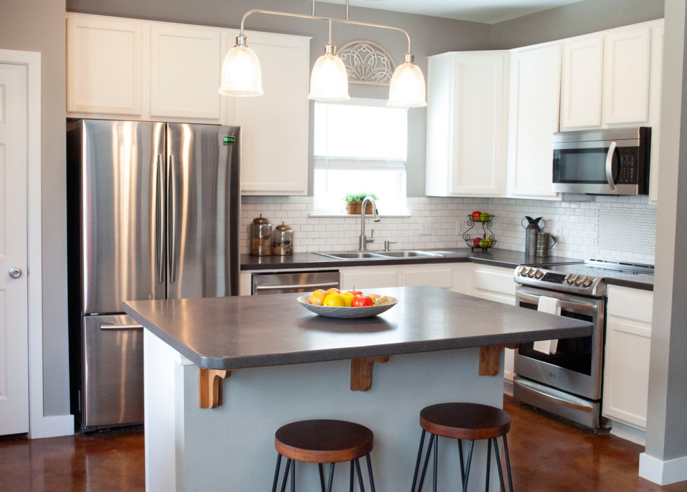 Idéer för att renovera ett mellanstort funkis grå grått kök, med en nedsänkt diskho, skåp i shakerstil, vita skåp, vitt stänkskydd, stänkskydd i tunnelbanekakel, rostfria vitvaror, betonggolv, en köksö och orange golv
