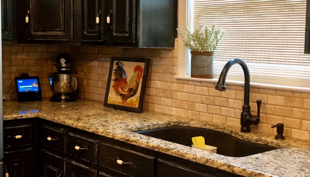 Inspiration for a timeless kitchen remodel in Miami with a double-bowl sink, dark wood cabinets, granite countertops, beige backsplash, travertine backsplash and stainless steel appliances