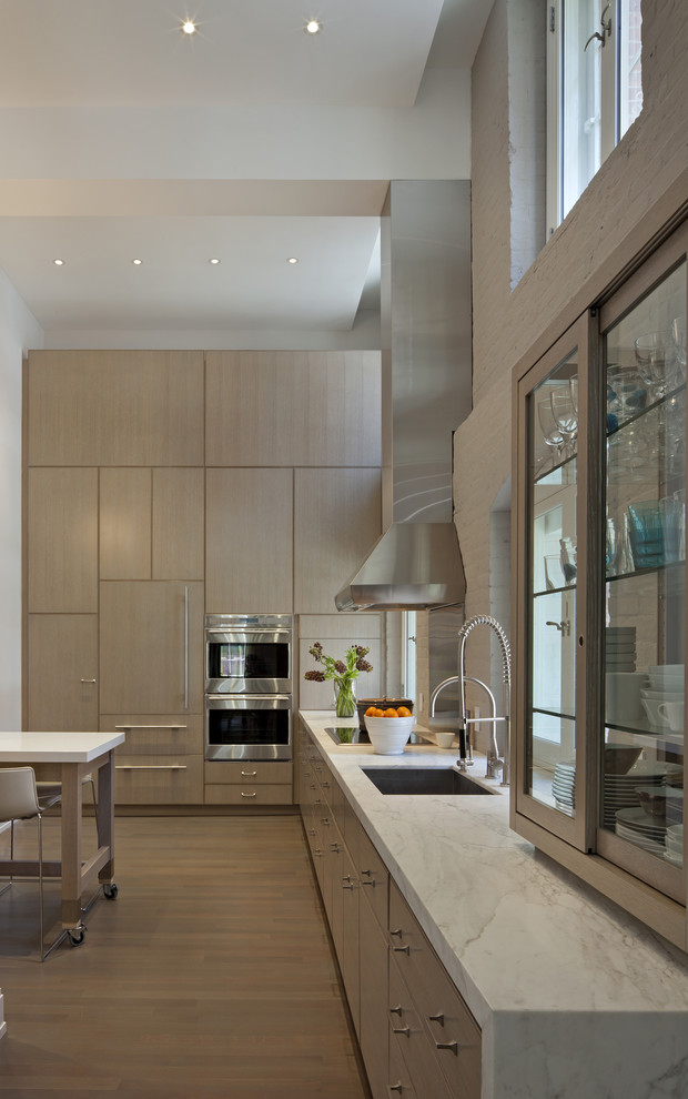 Example of a minimalist kitchen design in New York with stainless steel appliances