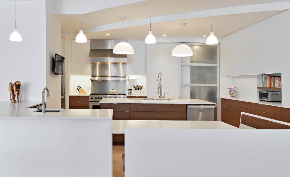 Exempel på ett stort modernt kök, med en undermonterad diskho, släta luckor, vita skåp, granitbänkskiva, vitt stänkskydd, stänkskydd i metallkakel, rostfria vitvaror, ljust trägolv och en köksö