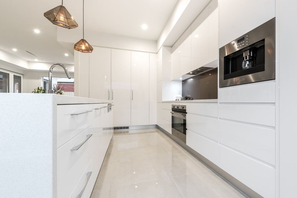 Inspiration for a medium sized contemporary l-shaped open plan kitchen in Adelaide with a submerged sink, flat-panel cabinets, white cabinets, engineered stone countertops, brown splashback, glass sheet splashback, stainless steel appliances, ceramic flooring and an island.