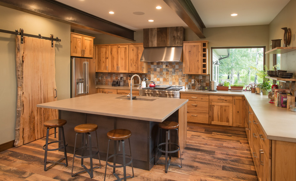 Kitchen - rustic u-shaped dark wood floor and brown floor kitchen idea in Other with an undermount sink, shaker cabinets, medium tone wood cabinets, brown backsplash, stainless steel appliances, an island and gray countertops