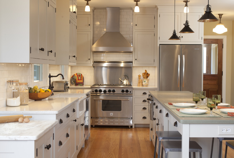 Inspiration for a traditional grey and cream kitchen in New York with a belfast sink and stainless steel appliances.