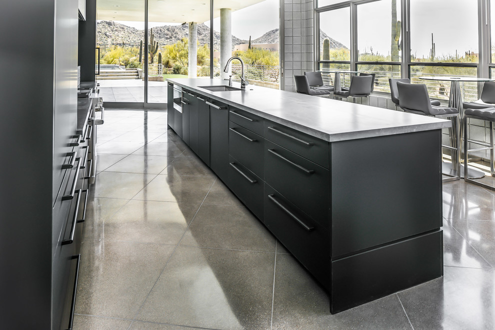 Eat-in kitchen - large contemporary single-wall porcelain tile and multicolored floor eat-in kitchen idea in Phoenix with an undermount sink, flat-panel cabinets, black cabinets, concrete countertops, gray backsplash, metal backsplash, stainless steel appliances and an island