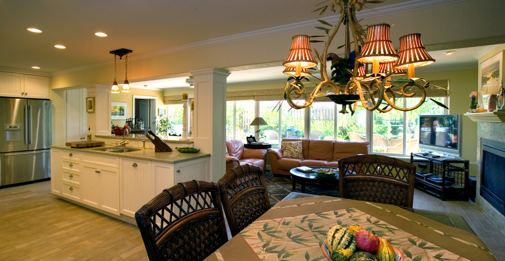 Example of an island style u-shaped eat-in kitchen design in Tampa with a double-bowl sink, beaded inset cabinets, white cabinets and stainless steel appliances