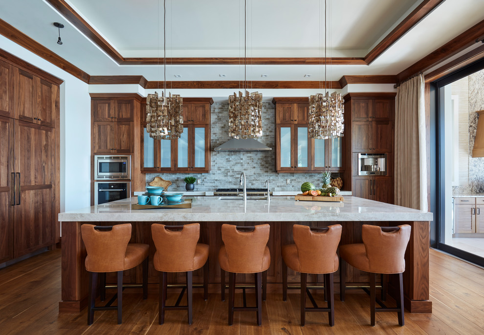 Kitchen - mid-sized tropical l-shaped medium tone wood floor and brown floor kitchen idea in Miami with an undermount sink, medium tone wood cabinets, quartz countertops, mosaic tile backsplash, stainless steel appliances, an island, shaker cabinets and gray backsplash