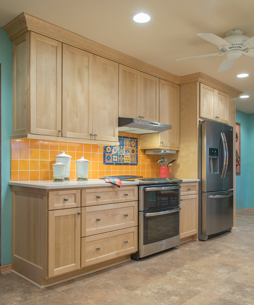 Inspiration for a large tropical galley vinyl floor kitchen remodel in Milwaukee with an undermount sink, shaker cabinets, light wood cabinets, quartz countertops, terra-cotta backsplash, stainless steel appliances and no island