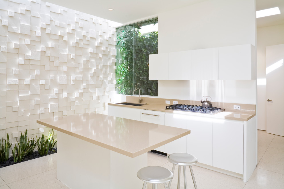 Inspiration for a contemporary kitchen remodel in Los Angeles with an undermount sink, flat-panel cabinets, white cabinets and an island
