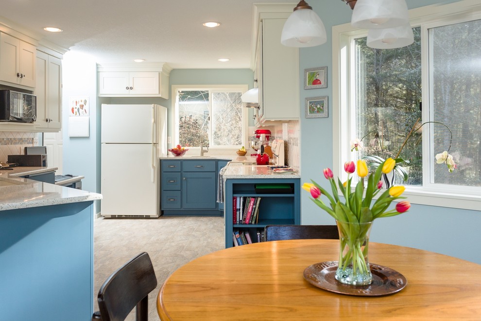 Mid-sized elegant u-shaped linoleum floor and beige floor eat-in kitchen photo in Portland with an undermount sink, shaker cabinets, blue cabinets, glass countertops, multicolored backsplash, ceramic backsplash, white appliances and a peninsula