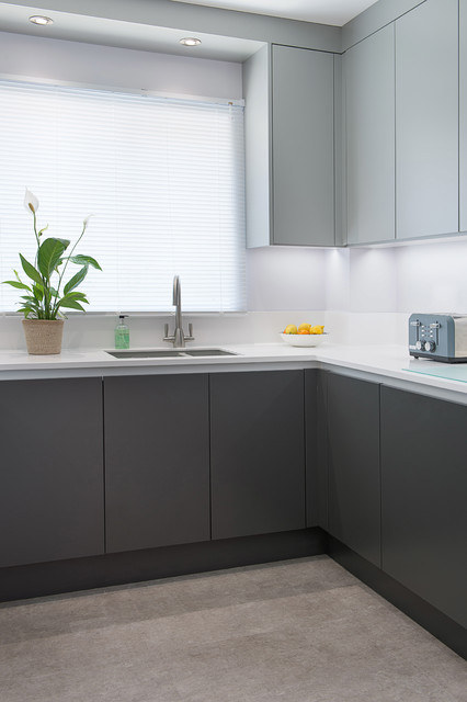 True handless monochrome panel door kitchen with Corian worktop ...