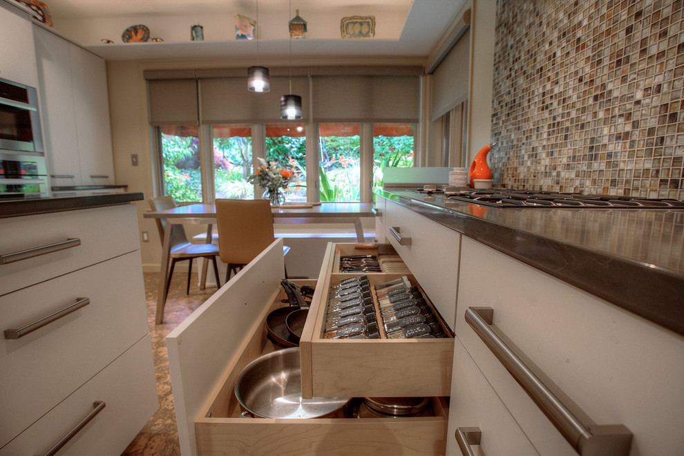 Large trendy cork floor enclosed kitchen photo in Seattle with an undermount sink, flat-panel cabinets, white cabinets, quartz countertops, beige backsplash, glass tile backsplash, stainless steel appliances and two islands
