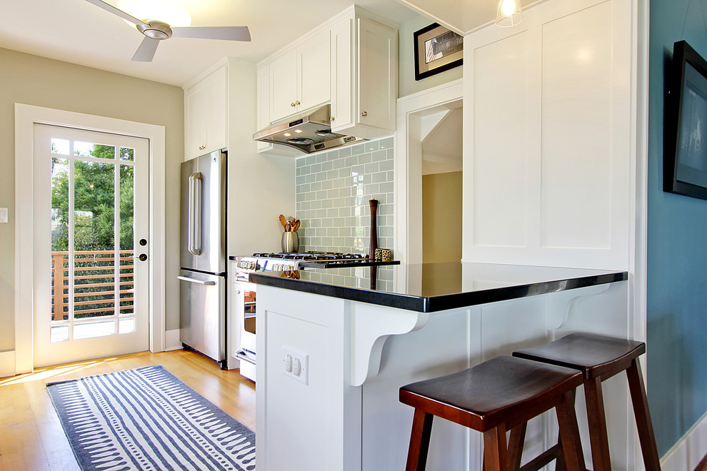 Kitchen - traditional kitchen idea in Seattle with recessed-panel cabinets, white cabinets, gray backsplash, stainless steel appliances and subway tile backsplash