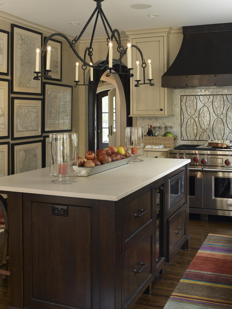 Example of a transitional kitchen design in Minneapolis with mosaic tile backsplash, stainless steel appliances, multicolored backsplash and dark wood cabinets